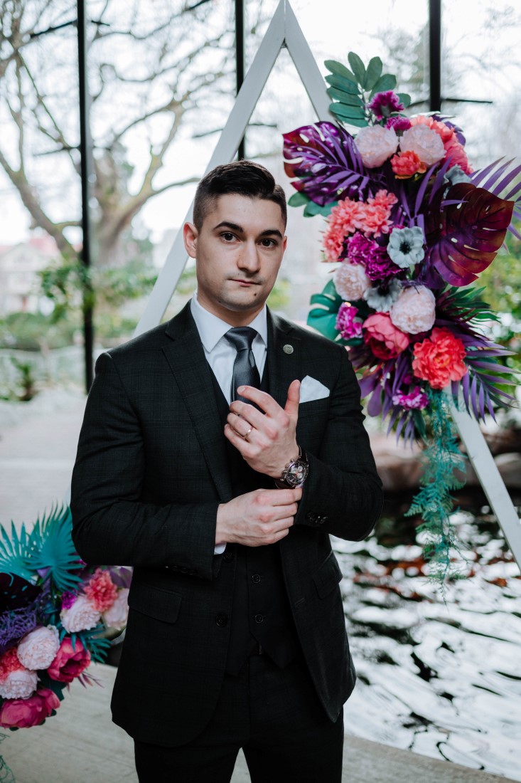 Groom fixes cuff of grey suit at Parkside Hotel Vancouver Island