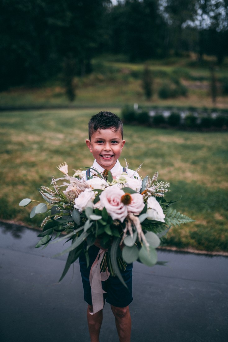 Little boy holds bouquet by AJR Floral Design Vancouver