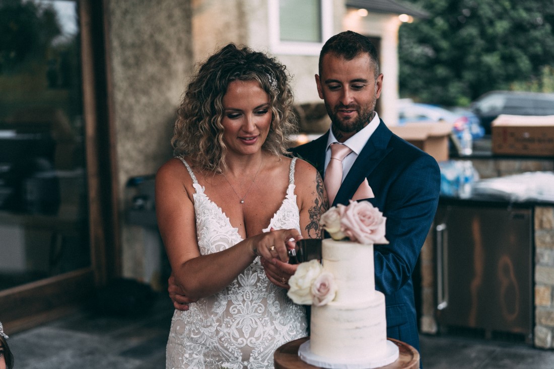 Bride and groom cut the wedding cake by Cake First Vancouver