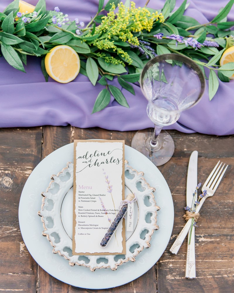 Lavender runner on wedding reception table with antique tableware