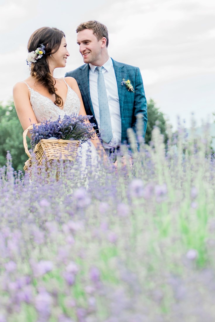 Wedding Lavender in Bloom bridal couple walk through field picking