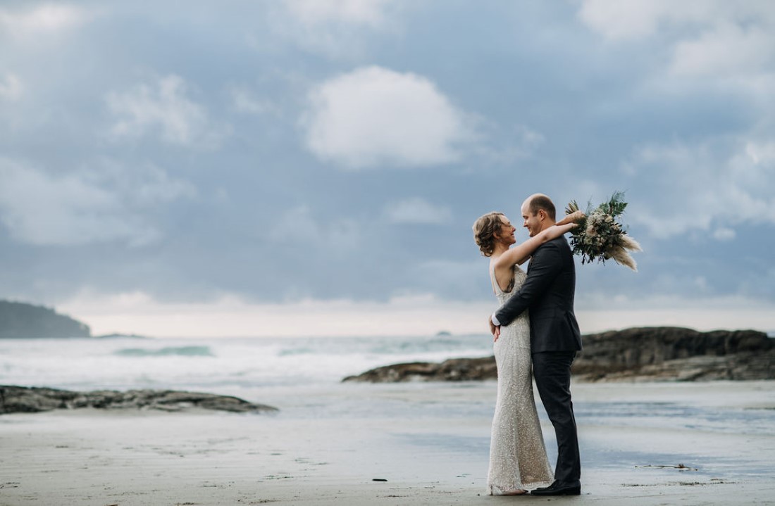 Tofino Beach Wedding couple embrace along the beach