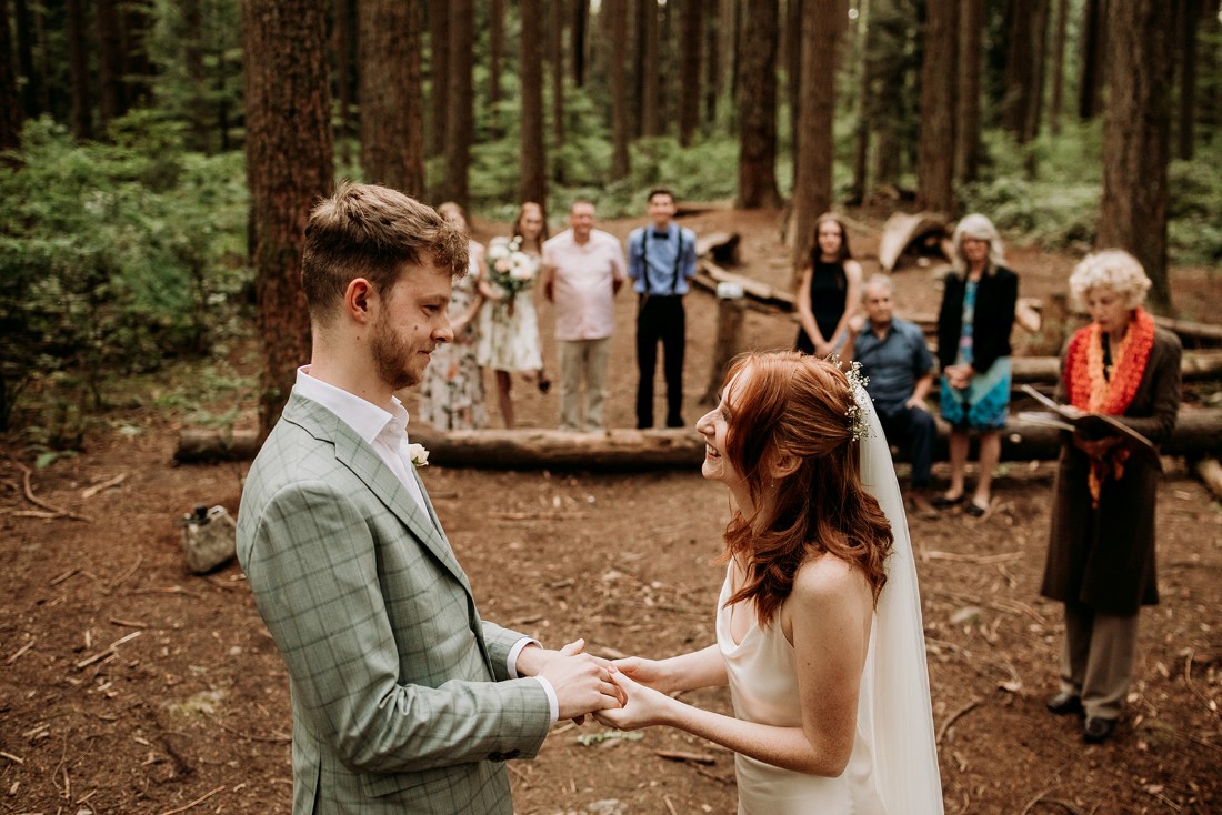 Guests look on as couple exchange vows in Vancouver forest elopement