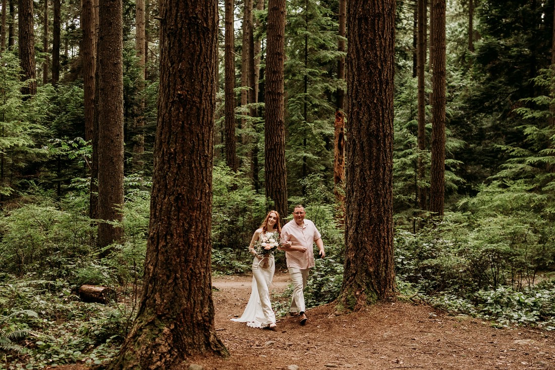 Heartfelt Elopement in Vancouver bride is walked through forest path by her father