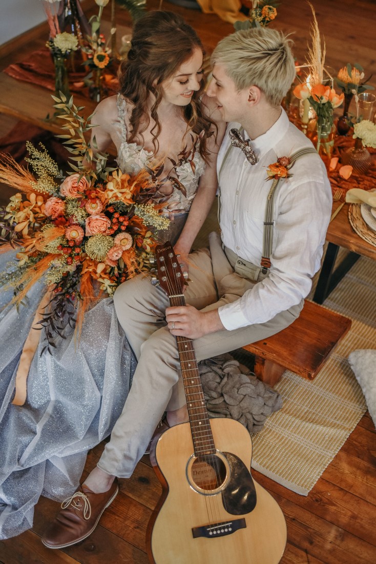 Deep Cove Winery Wedding Dayla Weiss Photo couple sitting with guitar