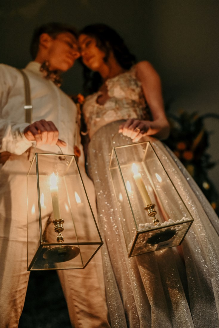 Deep Cove Winery Wedding Dayla Weiss Photo close up of bride and groom holding lit lanterns