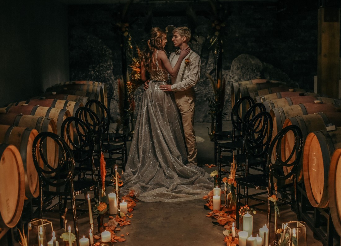 Deep Cove Winery Wedding Dayla Weiss Photo bride and groom embrace amidst wine barrels