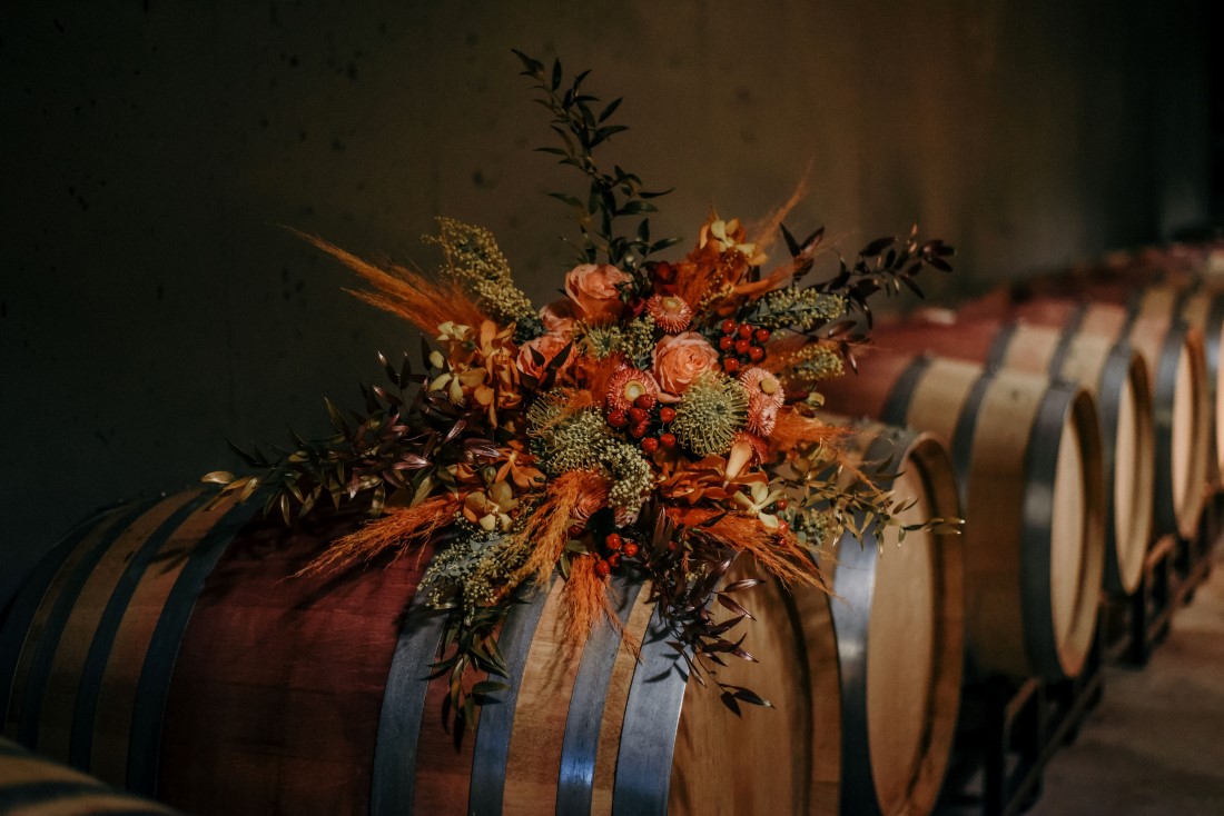 Deep Cove Winery Wedding Dayla Weiss Photo Bridal Bouquet on Wine Barrels