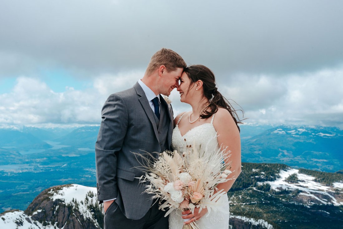 Wedding From Above Janayh Wright Photography sharing a moment on top of mountain