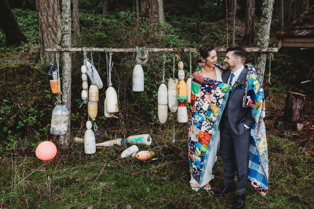 Changing Plans Anastasia Photography couple embrace under cozy quilt