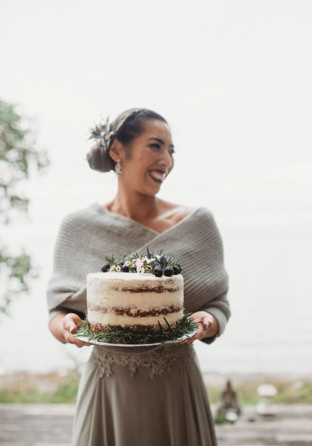 Changing Plans Anastasia Photography bride holding naked cake with evergreen