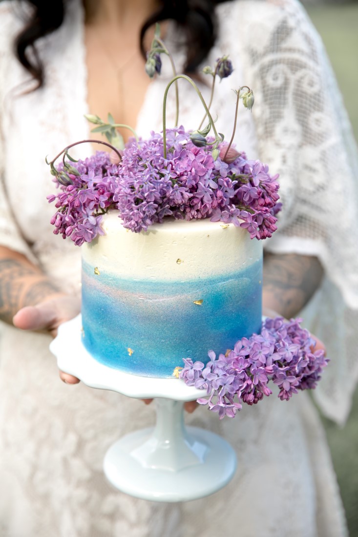 Purple Lilac Spring Wedding Hattie Root Photo bride holding Wedding cake