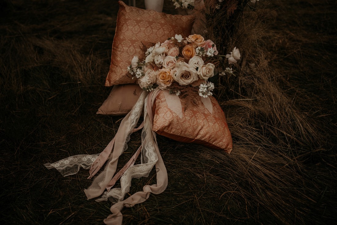 Romantic Cover for Vancouver Island Magazine Secret Waters Photography bridal bouquet with lace and ribbon tails lays on decorative pillows