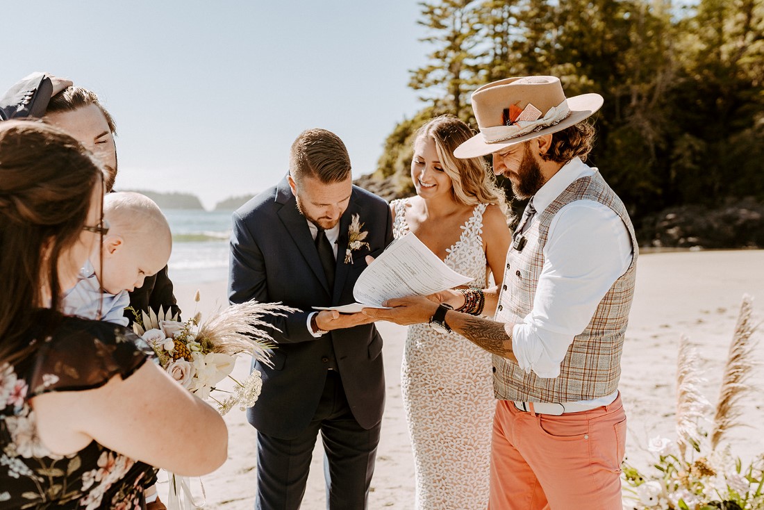 Couple exchange rings during beach wedding in Tofino