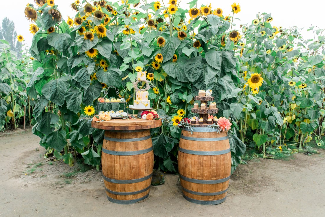 Sunflowers and Sunshine Wedding Inspo dessert table showcased on barrels