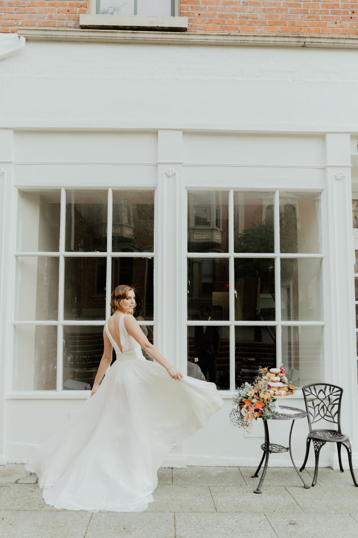 Coffee Love in Comox Valley Luke Liable Photography Bride twirling in front of cafe