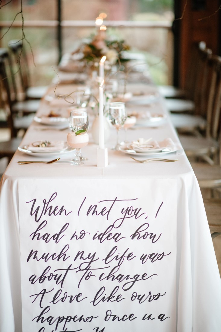 Calligraphy on receptable table linens with white decor at Dolphin's Resort