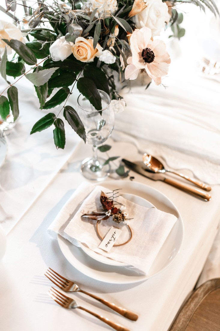 White on White reception table decor with gold cutlery