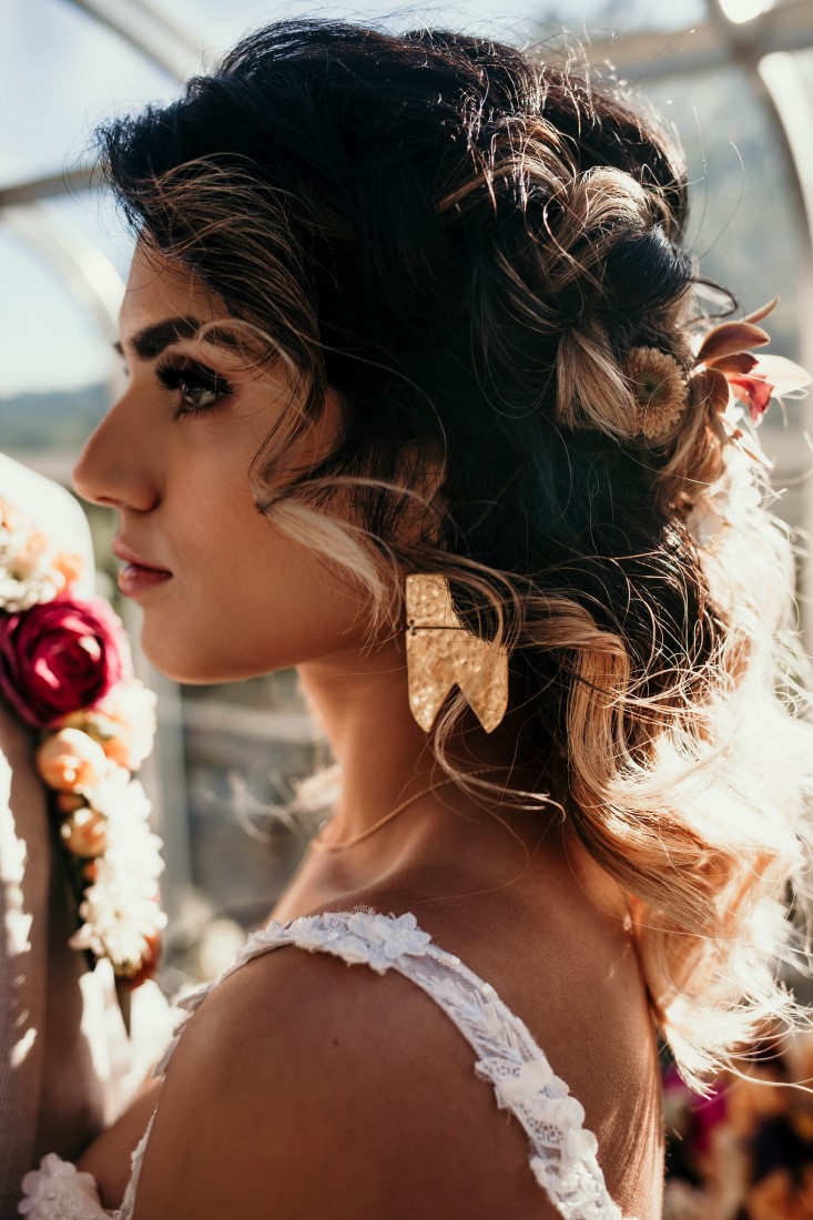 Bride with up do and flowers by Kendra Epp