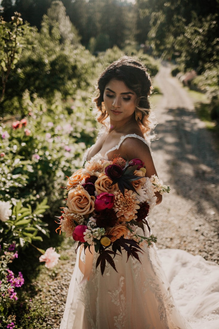 Bride holds lush bouquet of antique roses by Brown's the Florist Vancouver Island