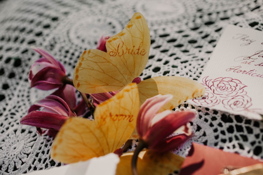 Paper butterflies for bride and groom on sweetheart table for elopement at HCP Gardens Vancouver Island