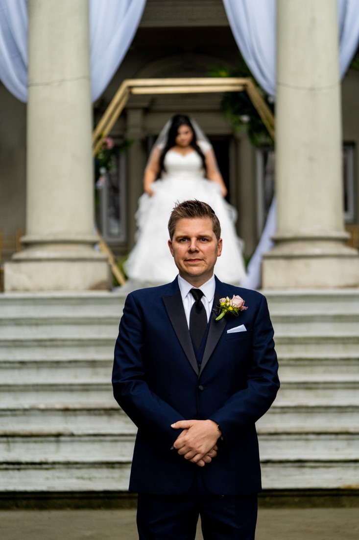 First Look for bride and groom on the stairs of Hycroft Manor in Vancouver