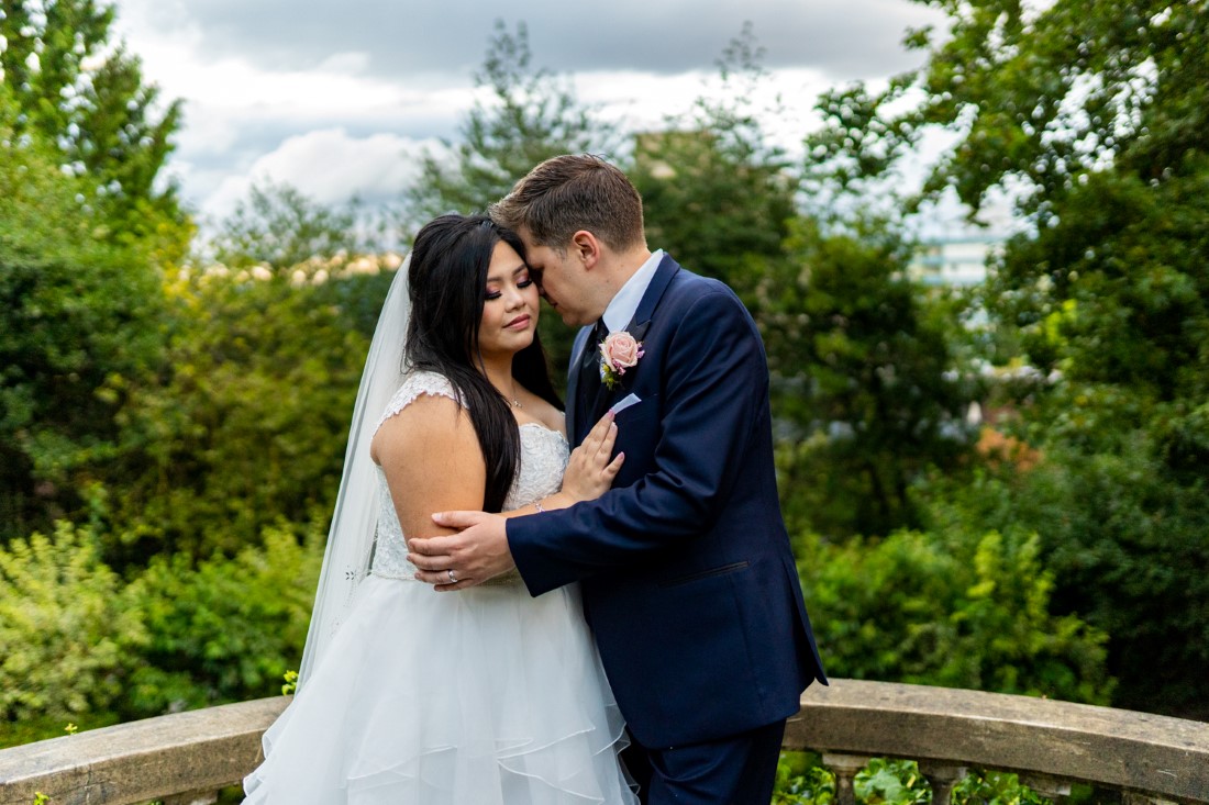 Bride and Groom embrace in the Gardens of Hycroft Manor