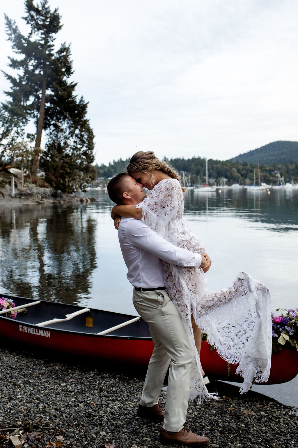 Groom lifts his bride out of a canoe