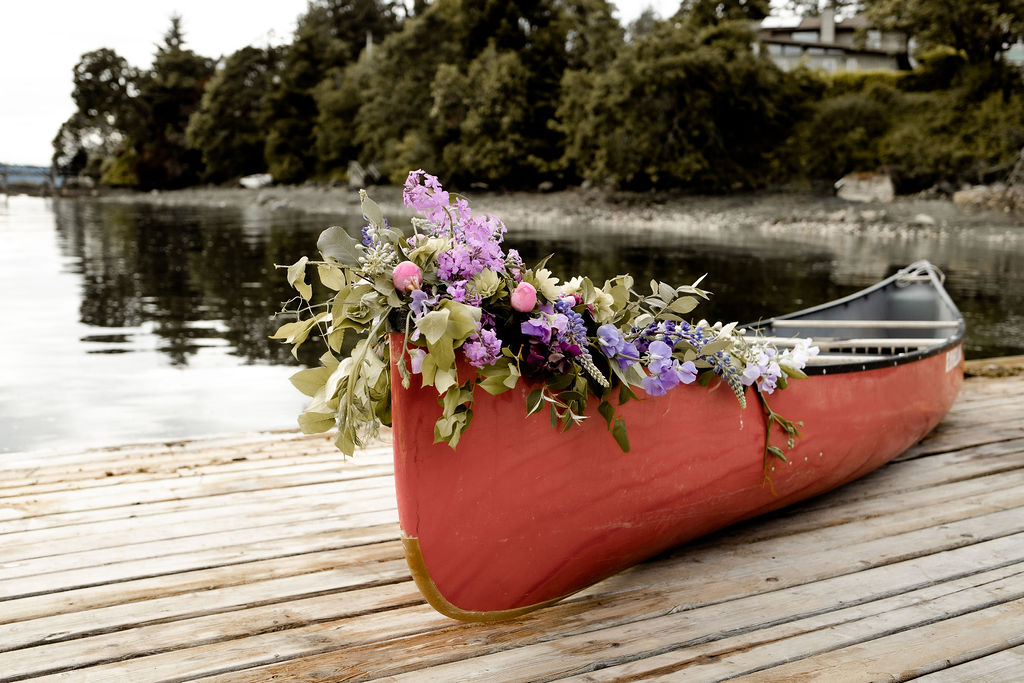 Flowers on the front of a canoe by Little Bee Blooms Vancouver Island